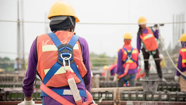 Scaffolders wearing safety harnesses